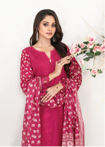 Woman wearing a pink traditional outfit with floral patterns, holding a floral arrangement.