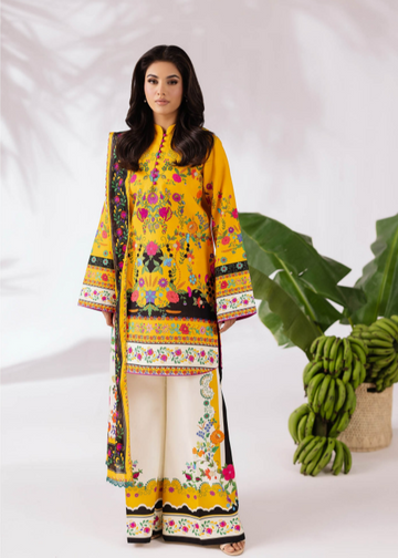 Woman wearing a yellow embroidered outfit with a white background and green plant.
