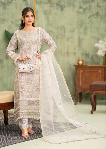 Woman in a traditional outfit with a floral design in a room setting