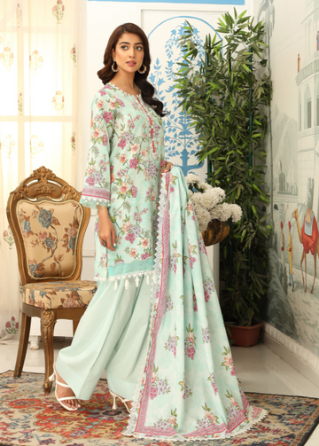 Woman in a light blue floral dress standing in a decorated room with a chair and plants.