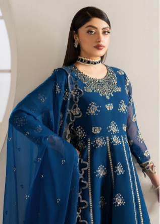 Woman wearing a blue embroidered traditional outfit with a matching dupatta.