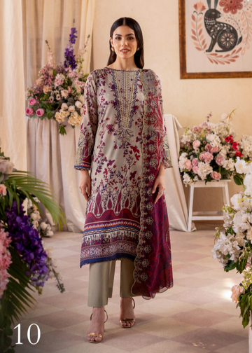 Woman in a floral embroidered outfit standing in a decorated room with flowers and a painting.