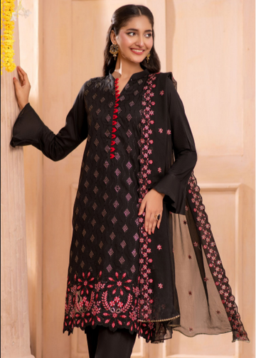 Woman wearing a black and pink embroidered traditional outfit with a sheer dupatta.