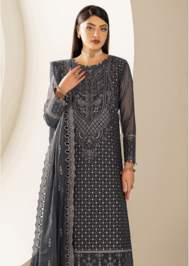 Woman wearing a dark blue embroidered traditional outfit against a neutral background