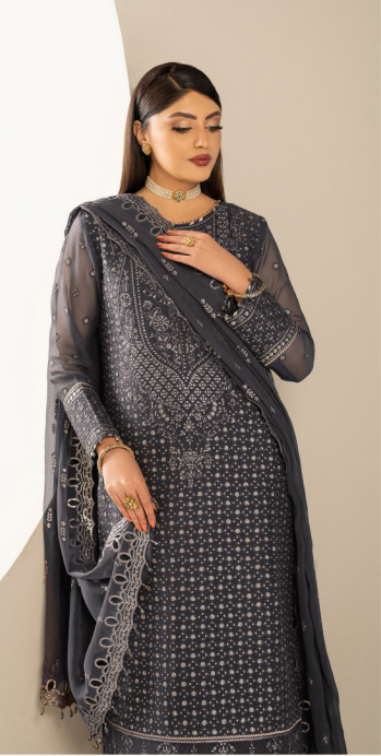 Woman wearing a dark gray traditional outfit with intricate patterns on a beige background