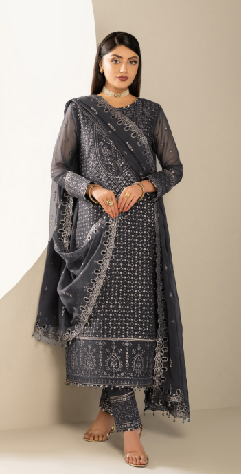Woman wearing a dark blue traditional outfit with a matching dupatta against a neutral background