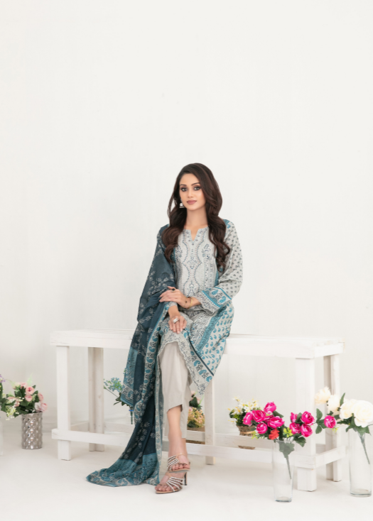 Woman in a blue and white traditional outfit sitting on a white bench with floral decorations.