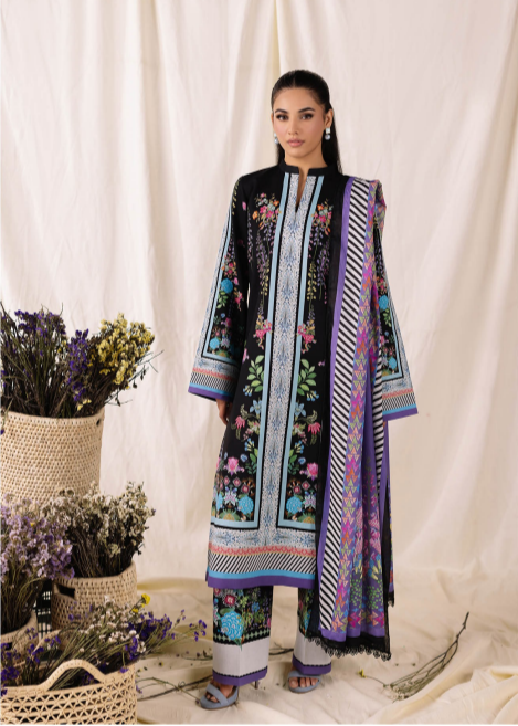 Woman wearing a colorful embroidered outfit with a white curtain background