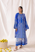 Woman wearing a blue embroidered traditional outfit with a white background