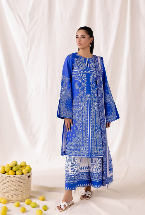 Woman wearing a blue embroidered traditional outfit with a white background