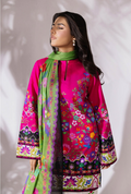 Woman wearing a colorful embroidered outfit with a green scarf against a white background