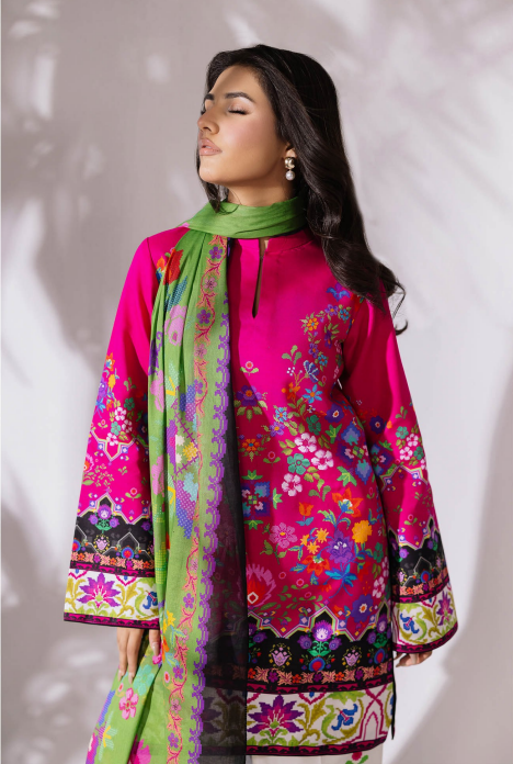 Woman wearing a colorful embroidered outfit with a green scarf against a white background