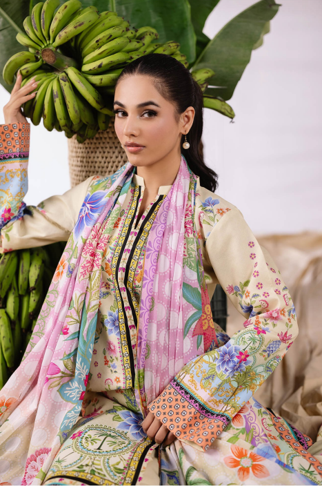 Woman in a colorful traditional outfit holding a bunch of bananas with a leafy background