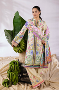 Woman wearing a colorful traditional outfit with a floral pattern, standing next to bananas and leaves.