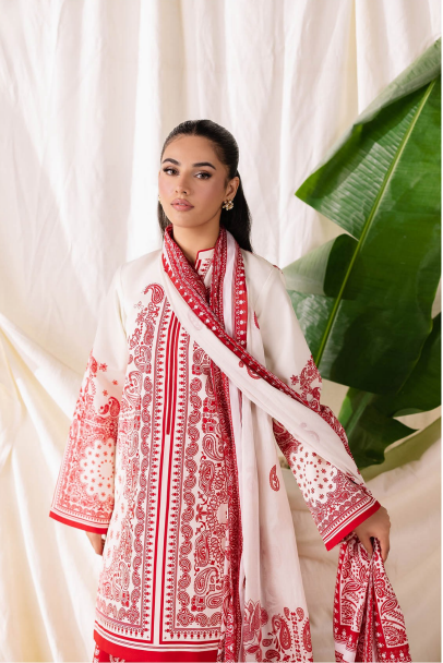 Woman wearing a white and red embroidered traditional outfit with a large leaf in the background