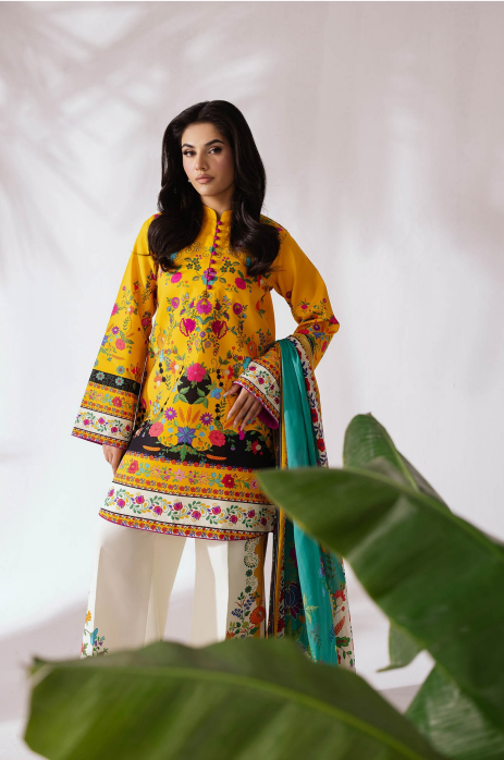 Woman wearing a yellow embroidered outfit with a white background