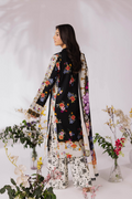 Woman wearing a floral embroidered outfit with a white background and decorative plants.