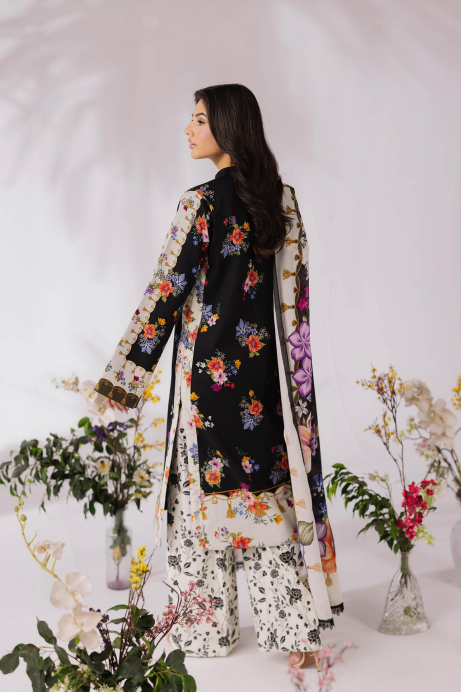 Woman wearing a floral embroidered outfit with a white background and decorative plants.
