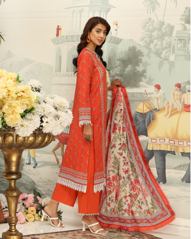 Woman in a red traditional outfit with a floral dupatta against a decorative background