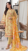 Woman wearing a light yellow floral dress with an orange dupatta in a room setting.