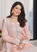 Woman wearing a peach and gray traditional outfit with white lace details indoors.