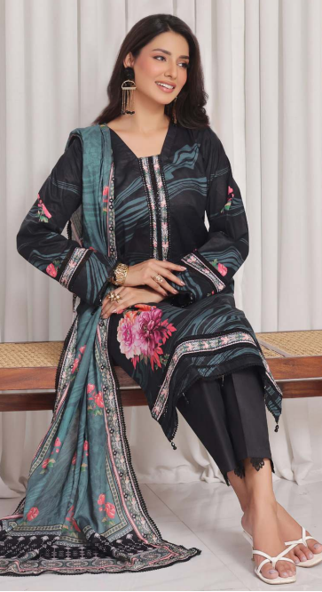 Woman wearing a black and floral traditional outfit with a green dupatta.
