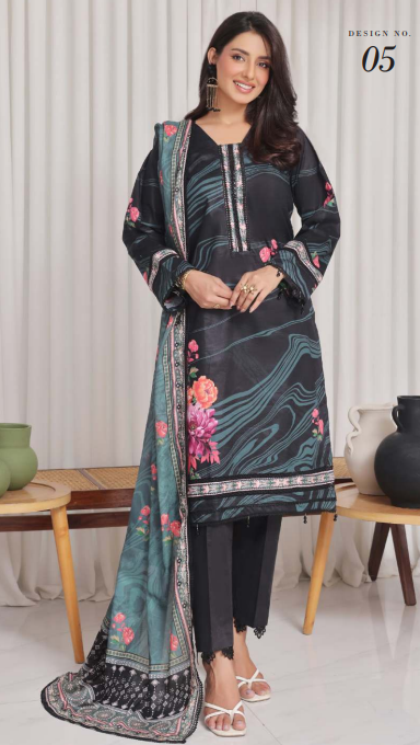 Woman wearing a black and floral dress with a matching dupatta in a minimalistic setting.