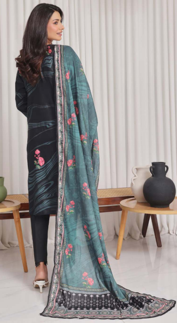 Woman holding a teal embroidered scarf in a room with white curtains and decorative items.