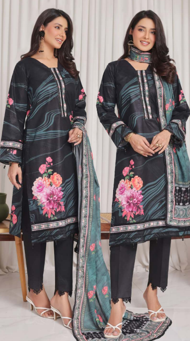 Two women wearing black floral embroidered suits with a white curtain background