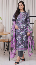 Woman wearing a floral dress with a purple dupatta in a minimal indoor setting