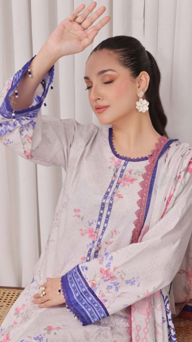 Woman wearing a traditional outfit with floral patterns and embroidery.