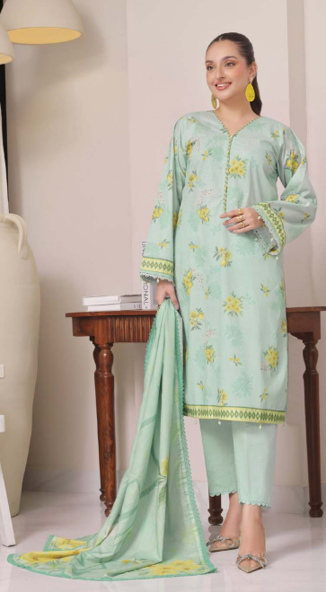 Woman wearing a light green embroidered outfit with a matching dupatta in a room.