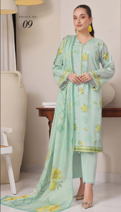 Woman wearing a light green embroidered outfit with yellow patterns in a minimal indoor setting.