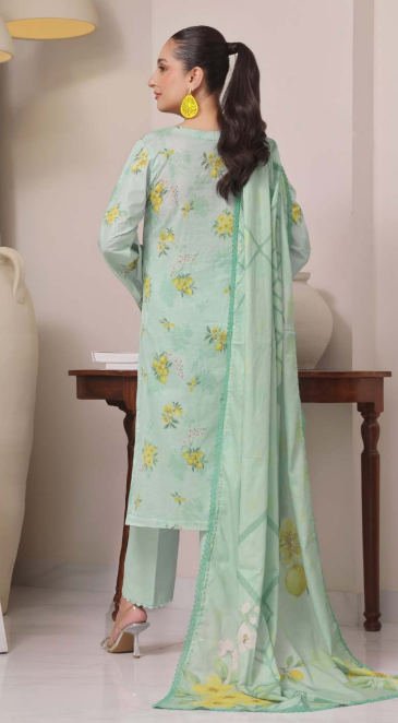Woman wearing a light green floral outfit with a matching dupatta in a minimal indoor setting.