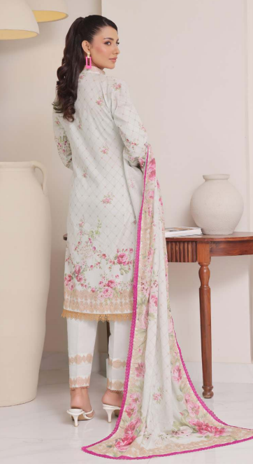 Woman wearing a light-colored traditional outfit with floral patterns in a minimalistic setting.
