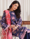 Woman wearing a floral dress with a pink dupatta in an indoor setting