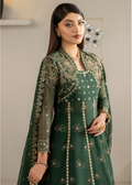 Woman wearing a green embroidered traditional outfit with gold details.