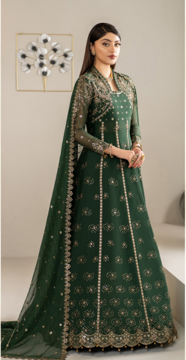 Woman wearing a green embroidered traditional outfit with a matching dupatta.