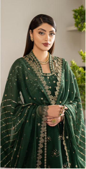 Woman wearing a green embroidered traditional outfit with a neutral background