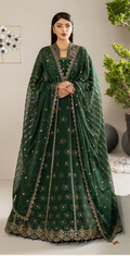 Woman wearing a green embroidered traditional outfit with a plain background