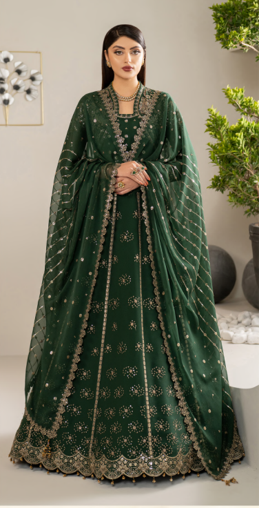 Woman wearing a green embroidered traditional outfit with a plain background