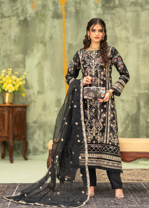 Woman in a black and white embroidered traditional outfit with a floral background