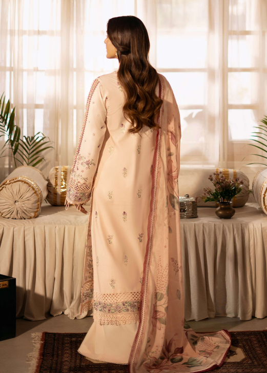 Woman in a peach traditional outfit standing in a room with draped curtains and decorative elements.