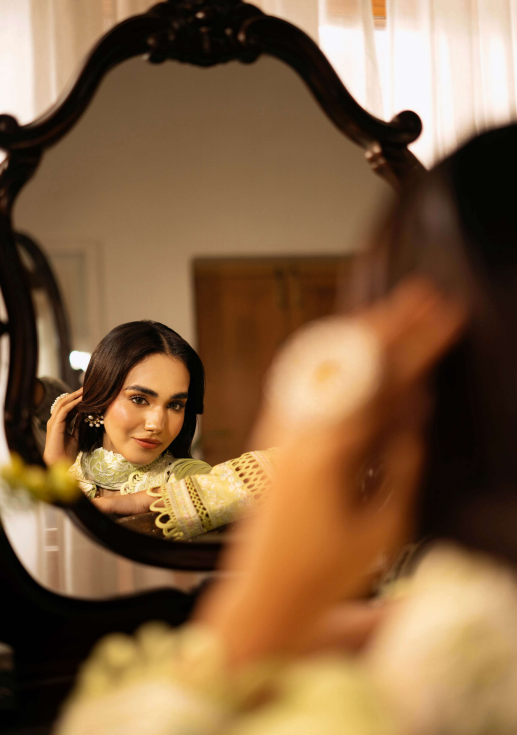 Woman looking at herself in a vintage mirror