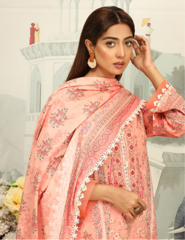 Woman wearing a pink floral saree with a blurred architectural background