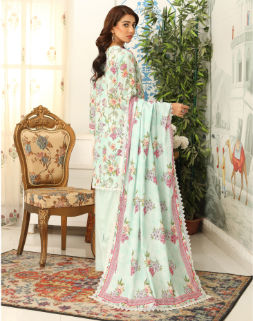 Woman in a floral dress standing in a decorated room with a chair and plants.