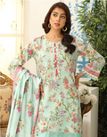 Woman wearing a light blue floral dress in an indoor setting with decorative elements.