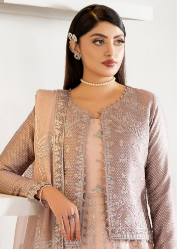 Woman wearing a beige embroidered outfit with a white background