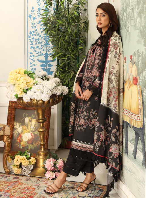 Woman in traditional attire standing in a decorated room with flowers and artwork.