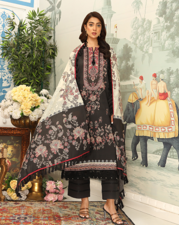 Woman wearing a black and white floral embroidered dupatta in a decorated room.